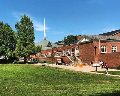 Exterior view of the southeast corner of the Charles B. Degenstein Campus Center under a sunny, blue sky